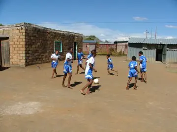 Children playing sports in schoolyard