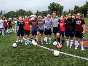 Youth soccer team posing on field